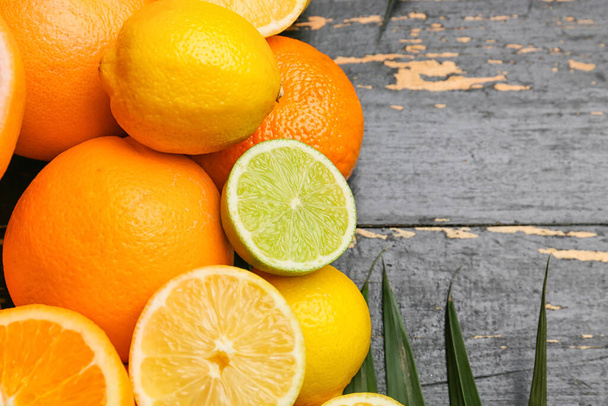 Fresh citrus fruits on dark wooden background - Photo, Image