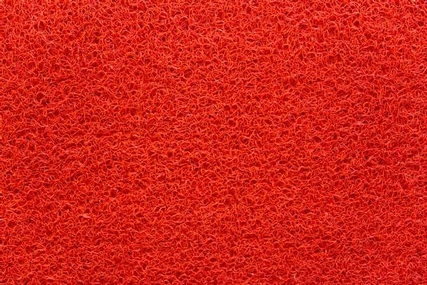 Porous marerial made of red synthetic thread, bright background - Photo, image
