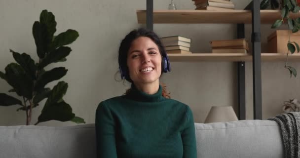 Happy young beautiful woman in headphones holding video call. - Imágenes, Vídeo