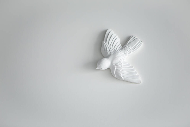 Глиняний керамічний камінь фігури скульптури моделювання птахів на білій стіні у вітальні. Стиль оформлення мінімалізму. Зображення з копією порожнього простору
. - Фото, зображення