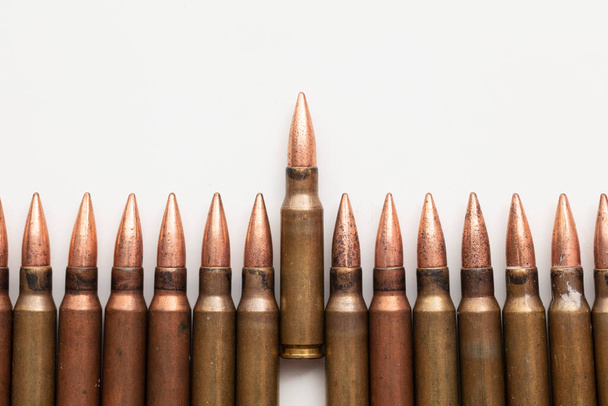 Close up of a line of bullets against a white background - Foto, Imagem