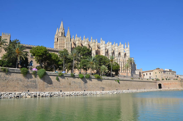 Beautiful antique cathedral by the sea in Mallorca. Summer town by the sea. Mallorca is a beautiful island. Beautiful cathedral. - Photo, Image