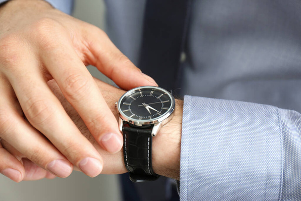 Man wearing luxury wrist watch with leather band, closeup - Zdjęcie, obraz