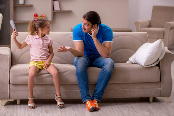 Young man with his daughter at home - Photo, Image
