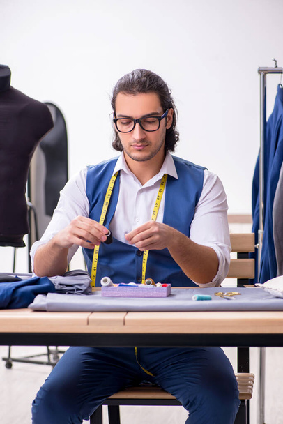 Young male tailor working at workshop - Photo, Image