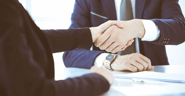 Business people or lawyers shaking hands finishing up a meeting, close-up. Negotiation and handshake concepts - Foto, Imagen