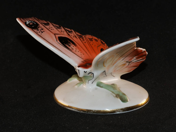 Porcelain butterfly figurine isolated on black background - Photo, Image