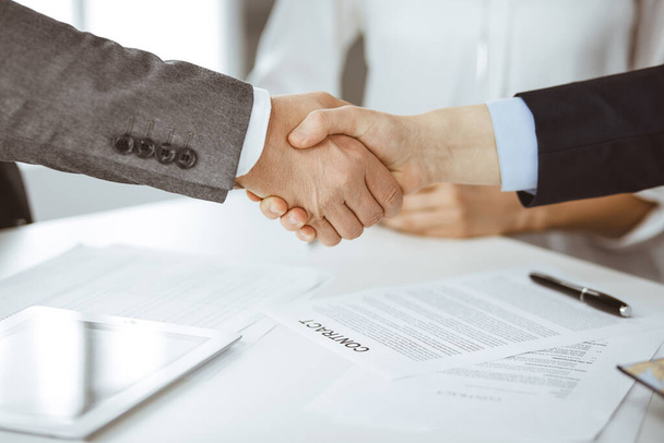 Business people shaking hands finishing contract signing, close-up. Business communication concept. Handshake and marketing - Valokuva, kuva