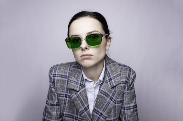 woman in green glasses and gray plaid suit - Zdjęcie, obraz