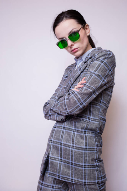 woman in green glasses and gray plaid suit - Foto, Bild