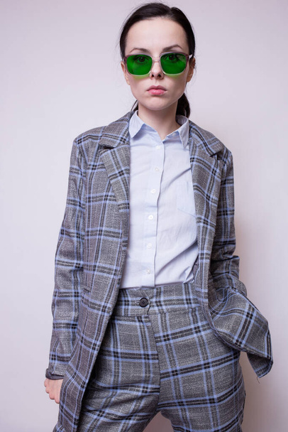 woman in green glasses and gray plaid suit - Fotoğraf, Görsel