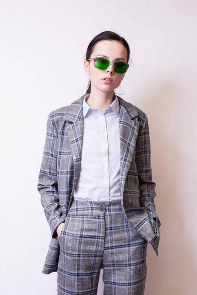 woman in green glasses and gray plaid suit - Foto, Imagen