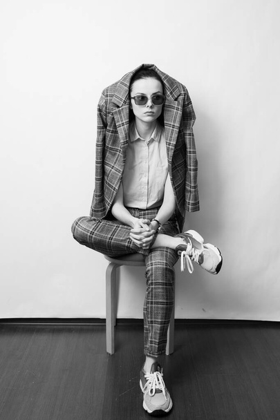 woman in green glasses and gray plaid suit - Фото, зображення