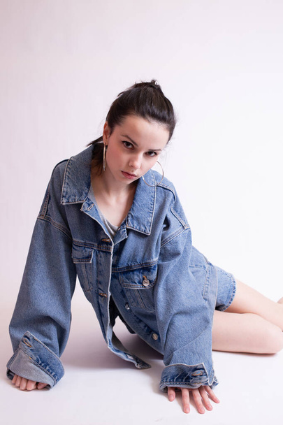 woman in denim jacket and shorts, on white studio background - Foto, Imagen