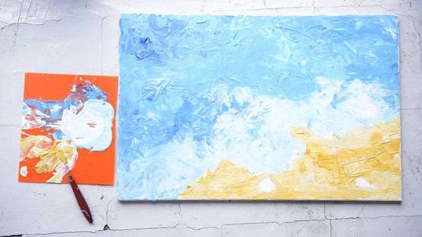 Ocean acrylic painting with palette knife on canvas with blue and turquoise as sea water and wave. Golden sand on beach with trowel texture technic. Water splash art hand paint.  Summer and seascape feeling and tone. - Photo, Image