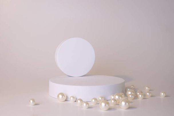 White podium on the white background with pearls. Podium for product, cosmetic presentation. Creative mock up. Pedestal or platform for beauty products. - Foto, afbeelding