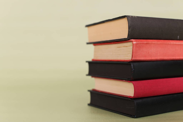 Stack of books on green background - Foto, immagini