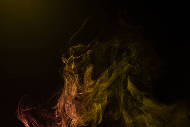 Yellow and pink steam on a black background. Copy space. - Fotó, kép