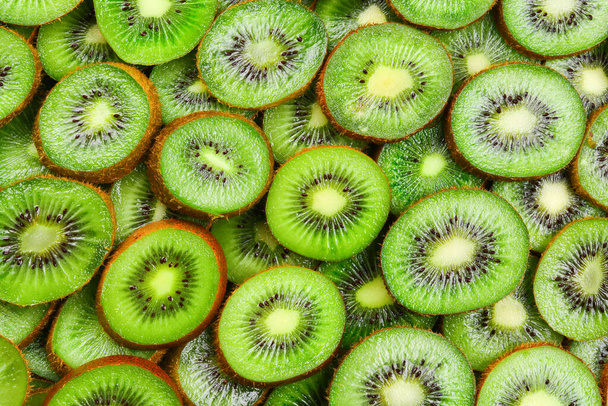 Top view of heap of sliced kiwi as textured background. - Photo, Image