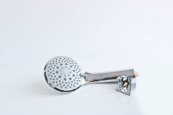 Shower head and wall mount on a light background. Plumbing accessories. - Φωτογραφία, εικόνα