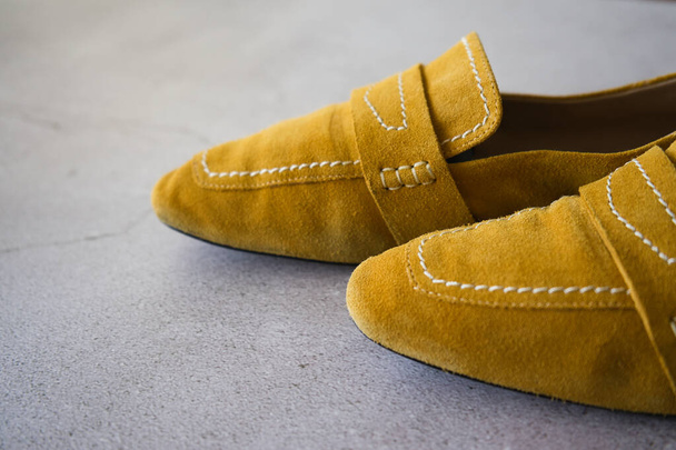 Yellow shoes on gray background. Yellow moccasins. - Photo, Image