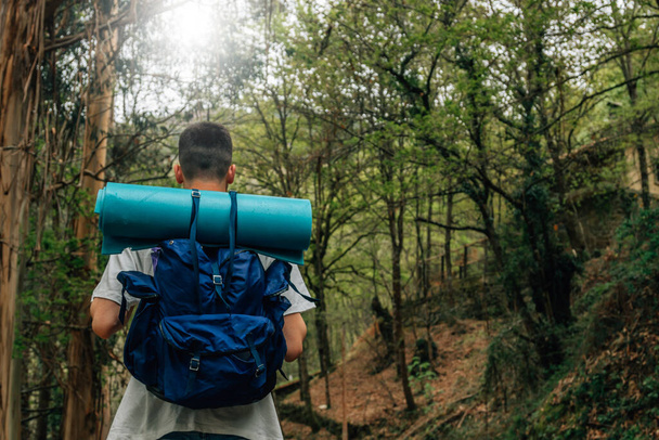 young man with backpack doing trekking or hiking - Photo, Image