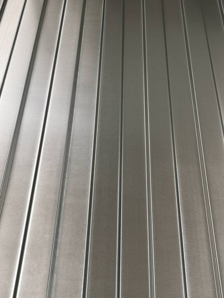 Galvanized metal sheet for fence or other building needs, for sale in the store - Φωτογραφία, εικόνα