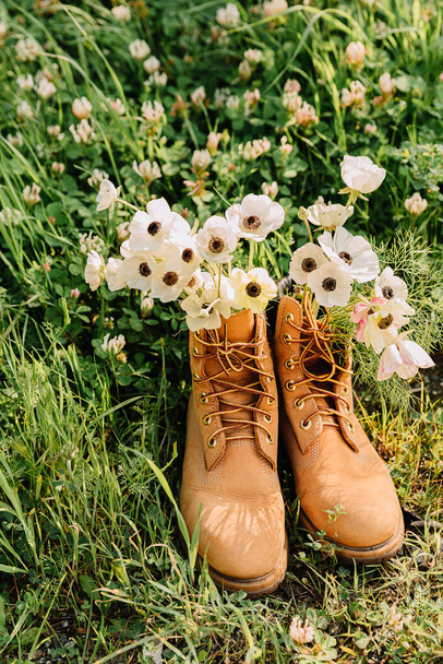 Shoes with a bouquet of white wildflowers anemone inside. - Photo, Image