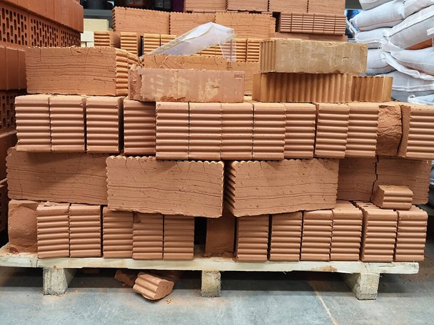 Pallet with red bricks in a large building materials store, construction concept - Fotografie, Obrázek