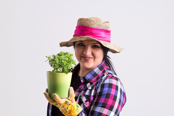 Reliable Woman in Gardening Apparel Holds a Green Plant - Photo, Image