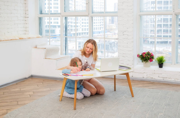 Happy Caucasian Mom With Daughter Sitting On The Living Room Floor And Drawing Together, Spending Time With Their Family Doing Art - Valokuva, kuva