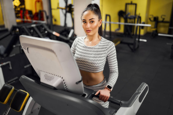 Young healthy woman cardio on a treadmill at the gym  - Фото, зображення