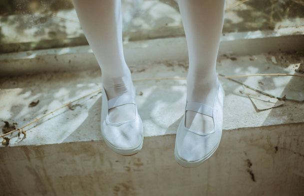 beautiful ballerina in white dress and shoes on the street - Zdjęcie, obraz