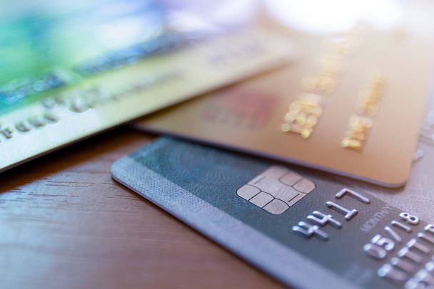 Close up of credit card soft focus and selective focus for background. soft focus close up credit card on wood table background - Foto, Imagen