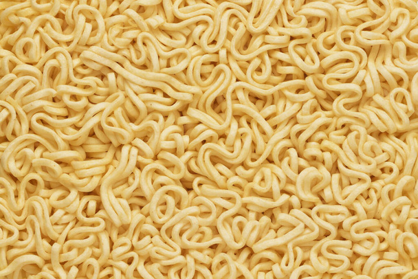 Dry raw instant noodles texture or background top view. - Photo, Image