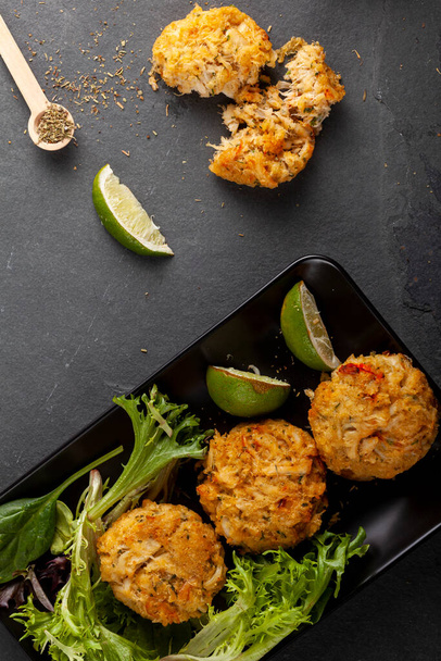 made with blue crab caught in Chesapeake bay, Crab cake is a favorite dish in the state of Maryland. Meat is mixed with sauces, crumbles, seasoning and vegetables and shaped in to patties to grill - Valokuva, kuva