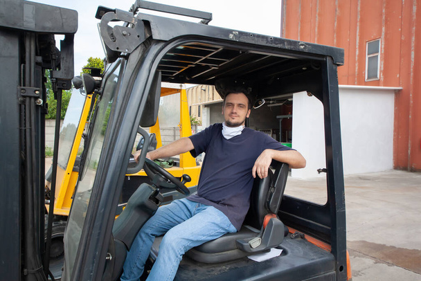 Worker operating an industrial forklift in a facility - Fotó, kép