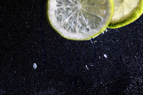 Water drops on ripe sweet lemon. Fresh lime  background with copy space for your text. Vegan and vegetarian concept. - Photo, image