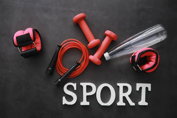 Sport and healthy lifestyle. Accessories for sports. Yoga mat dumbbell and jump rope. Sports background with home exercises concept. - Photo, Image