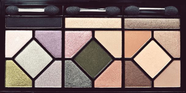 An eyeshadow palette of fifteen colors with three brushes - Photo, Image
