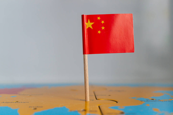 A small flag of China on a wooden stick fixed on the globe - Zdjęcie, obraz