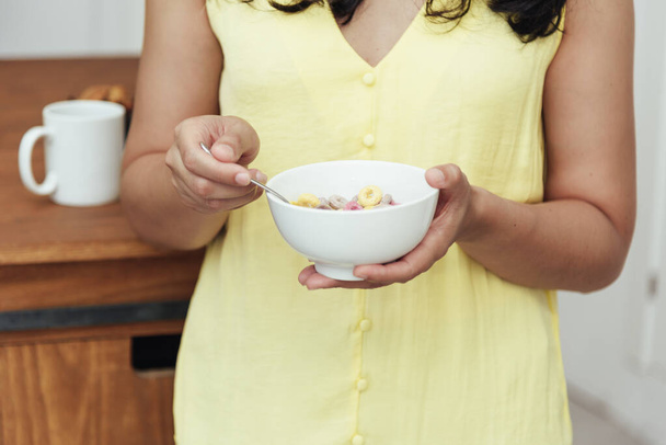 Close-up of a woman having breakfast at home. Domestic life concept. - Fotó, kép