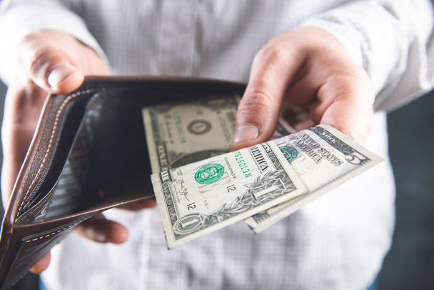 man withdraws money from wallet . - Фото, изображение