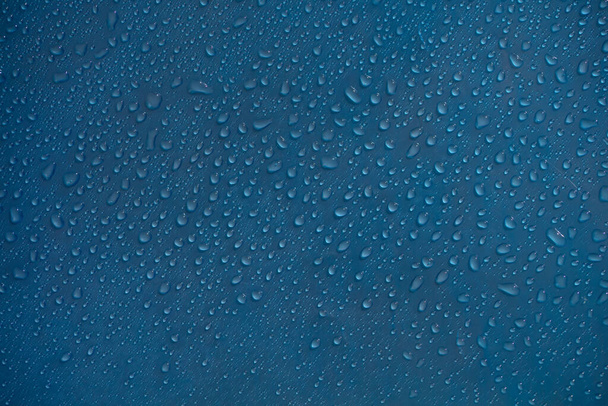 Dew drop pattern texture. Wet water on glass blue wallpaper or background. Bubble pattern. - Zdjęcie, obraz