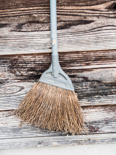 A closeup shot of an old broom in a street - Foto, Imagem