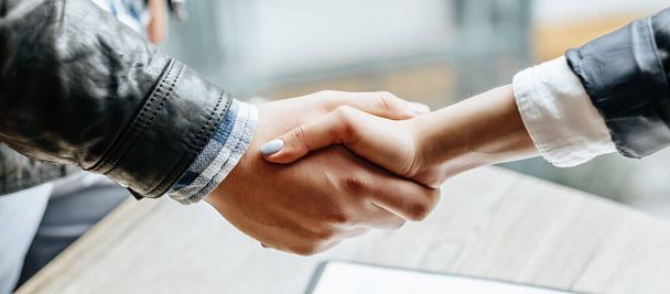 Man and woman hand shaking. Handshake after good cooperation, Businesswoman Shaking hands with Professional businessman after discussing good deal of contract. Business concept. - 写真・画像