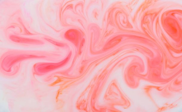 Abstract background pattern and texture of swirling pink ink creating a flowing wavy fluid effect in full frame for use as a design template - Photo, Image