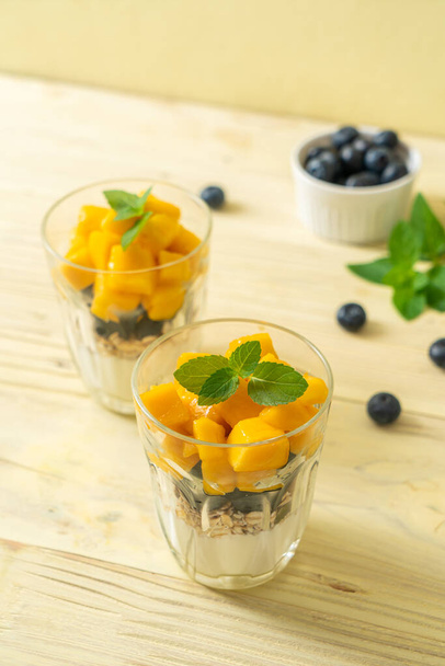 homemade fresh mango and fresh blueberry with yogurt and granola - healthy food style - Fotó, kép