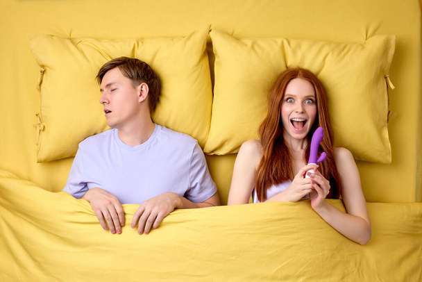 Its Time To Satisfy Yourself. Woman Is Going To Use Dildo While Husband Is Sleeping - Фото, изображение