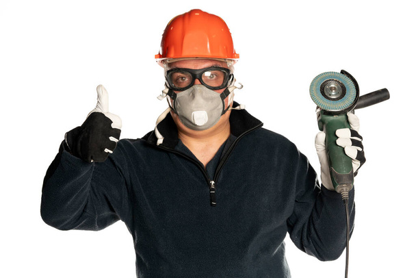 man with angle grinder and protective equipment on white background showing thumbs up - Photo, Image